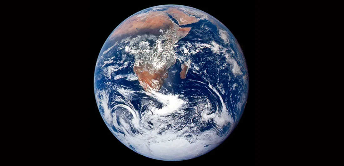 View of planet Earth from space, with blue oceans and brown land visible.