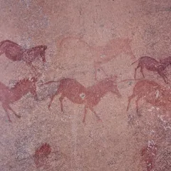 A prehistoric, reddish-brown painting of animals on a rock shelter in Mashonaland, Zimbabwe