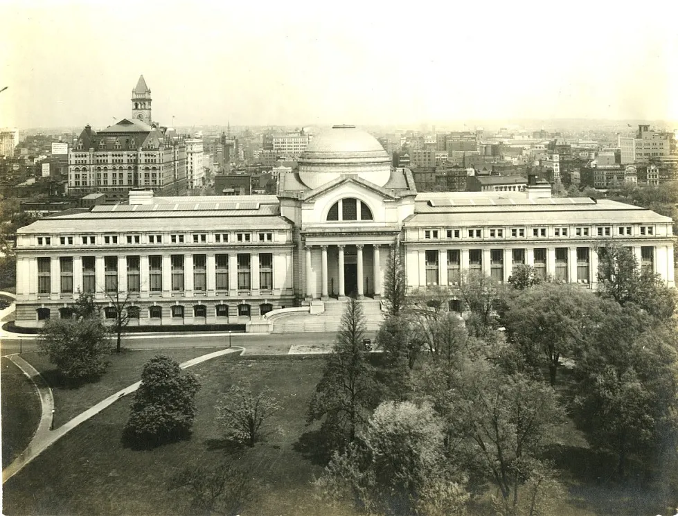 A large building featuring a dome and two wings